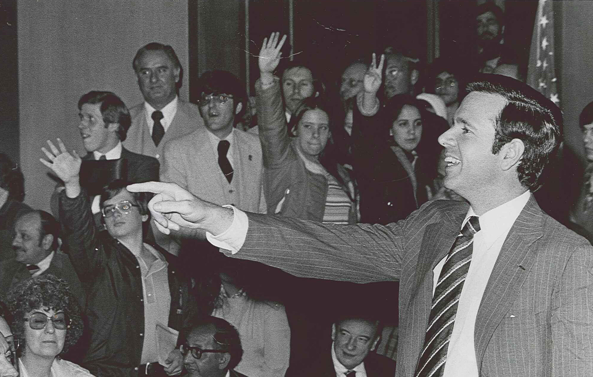 John Heinz pointing while smiling into crowd