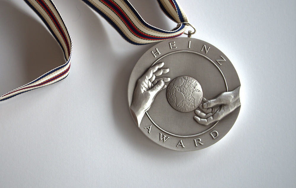 Shared Ideals Realized, the words of Senator Heinz in whose memory the Awards were created, are inscribed on the obverse side of the medallion given to each recipient of the Heinz Awards. On the reverse side, an image of a globe positioned between two hands symbolizes not only the concept of joining together to work for the greater good, but also the passing of stewardship over the earth and its inhabitants from one generation to the next.